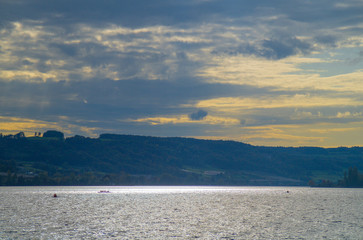 Sport rower on Lake Constance on a beautiful afternoon at the beginning of autumn in the back light.