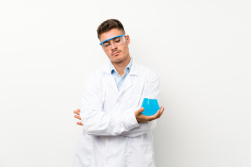 Young scientific holding laboratory flask over isolated background thinking an idea