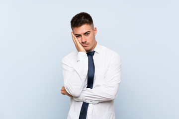 Handsome businessman over isolated blue background unhappy and frustrated