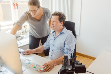 Woman and man working on a video in post-production