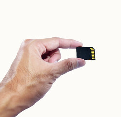 Hand holding memory card on white background
