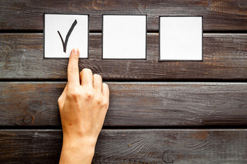Hand put check mark check-box on office background top view copy space