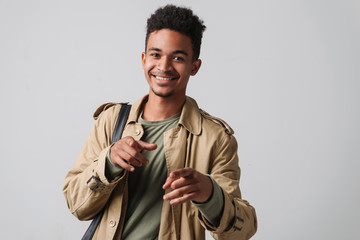 Image of happy african american guy pointing finger at camera