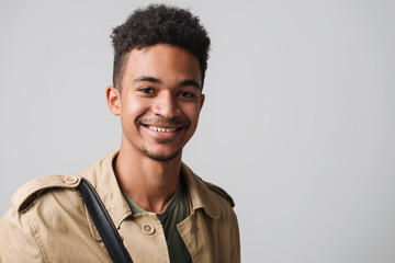 Image of happy african american guy smiling and looking at camera