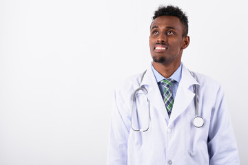 Young bearded African man doctor against white background
