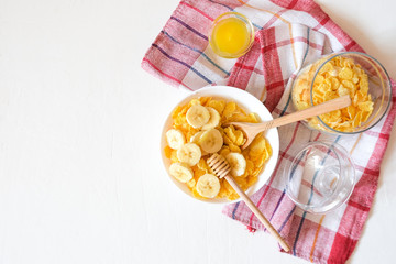 Traditional breakfast cereal of cornflakes and milk with a banana. Healthy lifestyle food.