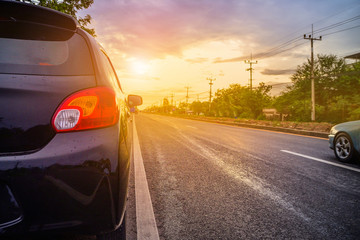 Fototapeta premium Car parked on road,car parked on street sunset background in spring nature day.
