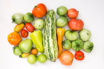 Summer harvest of vegetables concept. Set of green and red peppers, tomato and zucchini.