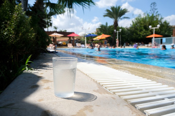 Fototapeta na wymiar Summer holidays in the open air pool. Rest is all inclusive. No alcohol drink soda.