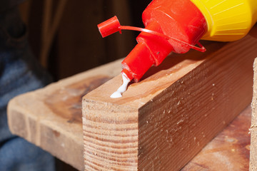 gluing of wooden products,worker put glue on a wooden furniture plank
