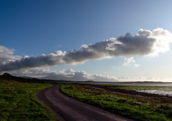 View of Welsh countryside on an Autumn day. A storm has just passed and bright sun contracts with the clouds. Could be used to illustrate the changing of seasons. Location, near to Caernarfon.