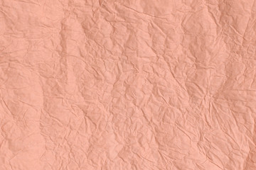 Trendy Cantaloupe colored textured background. Crumpled paper texture.