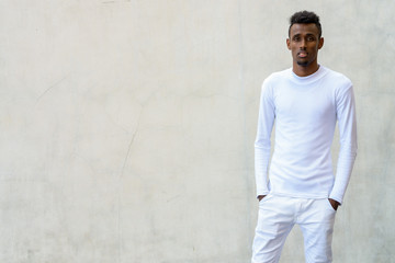 Young bearded African man wearing long sleeved white shirt again