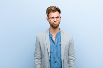 young businessman feeling confused and doubtful, wondering or trying to choose or make a decision...