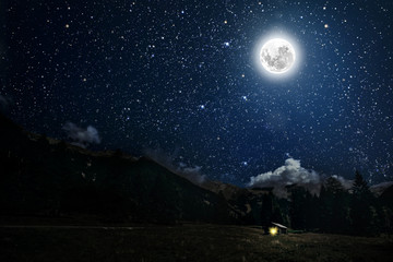 The moon shines over the manger of christmas of Jesus Christ.