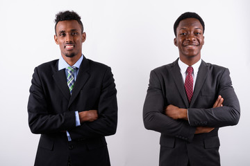 Two young African businessmen against white background