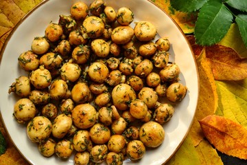 Fragrant fried champignons. Grilled mushrooms in a beautiful plate. Autumn leaves. Autumn composition with food, with mushrooms.