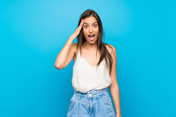 Young woman over isolated blue background has just realized something and has intending the solution