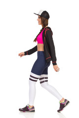 Walking Beautiful Young Woman In Sports Clothes. Side View.