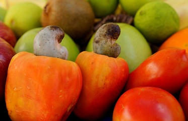 Cashews, tomatoes, kiwi fruit, limes and apples. Fruits background.