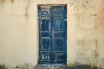 Background in the form of a shabby wall with a door texture peeling paint