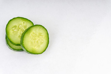 Sliced cucumber isolated on white background. Selective focus