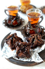 Eastern sweets and traditional tea on a white background