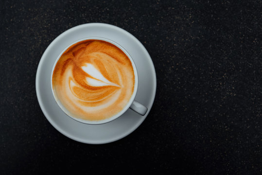 Fresh Italian Cappuccino Coffee In A White Cup On Black Background.