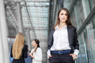Young female boss near a business center. Concept for business, boss, work, team and success.