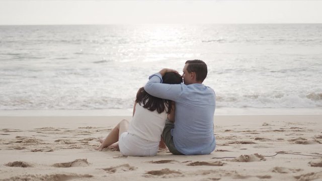 Young lovers on honeymoon hugging at beautiful sea beach