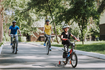 Fototapeta na wymiar Happy family enjoying bicycle ride in countryside
