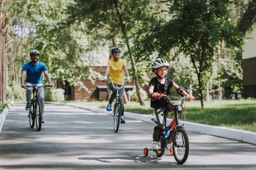 Happy family enjoying bicycle ride in countryside