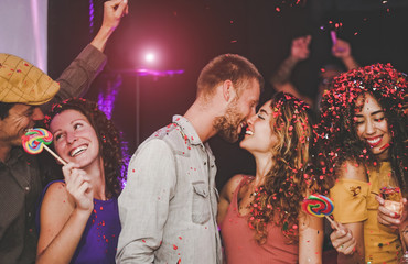 Group of happy friends doing party in nightclub - Young people having fun celebrating and dancing...