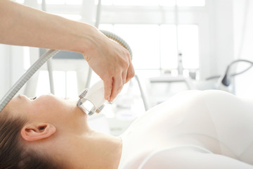 Obraz na płótnie Canvas Face lifting. A rejuvenating cosmetic care treatment in aesthetic medicine clinic.