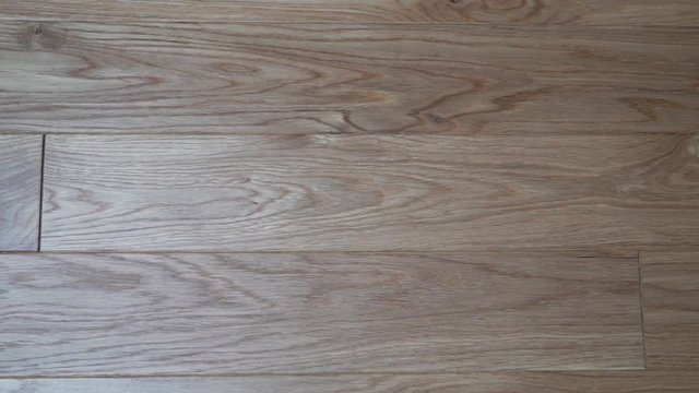 Close-up beautiful solid wood floor Board light oak with beautiful texture, camera slide from left to right