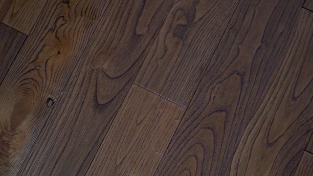 Close-up superb expensive solid wood floor walnut Board with beautiful texture, circular camera slide