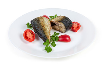 Baked slices of Atlantic mackerel with greens and tomatoes