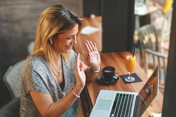 Woman have business meeting via video call in a cafe