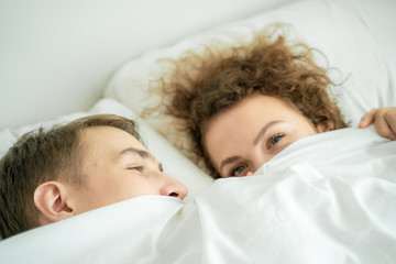 Close up portrait face of love couple lying on bed together