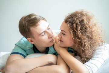 Close up portrait face of love couple lying on bed together
