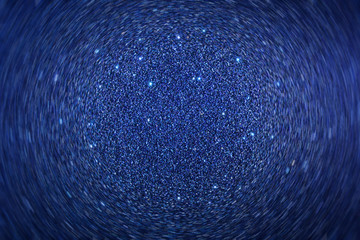 Blue sparkling background in the stage of rotational motion. Imitation of fractions of sand or...