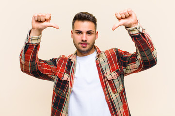 young hispanic man feeling proud, arrogant and confident, looking satisfied and successful,...