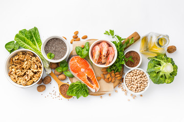 Food sources of omega 3 and omega 6 on white background top view. Foods high in fatty acids including vegetables, seafood, nut and seeds - obrazy, fototapety, plakaty