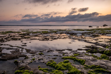 Seascape. Sunset at the beach. Ocean low tide. Horizontal background banner. Nyang Nyang beach, Bali, Indonesia.