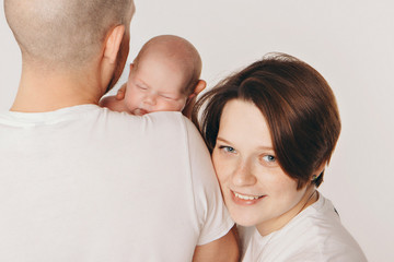 family photo on a white background: parents spend time with their children. mom and dad hug the baby. the concept of childhood, fatherhood, motherhood, IVF