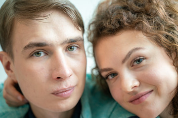 Close up portrait face of love couple lying on bed together