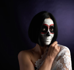 woman with black short hair in white makeup Sugar head to the day of the dead