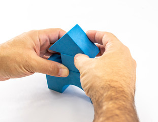 Man's hands perform a construction with constructive elements of a children's toy