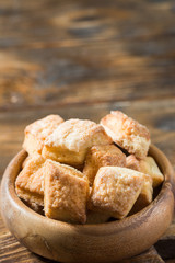 Cottage cheese cookies in a wooden bowl on a wooden table. Rustic style