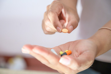 Various colored capsules placed in the hand Health care concept, capsule therapy, pharmaceutical industry, pharmacy